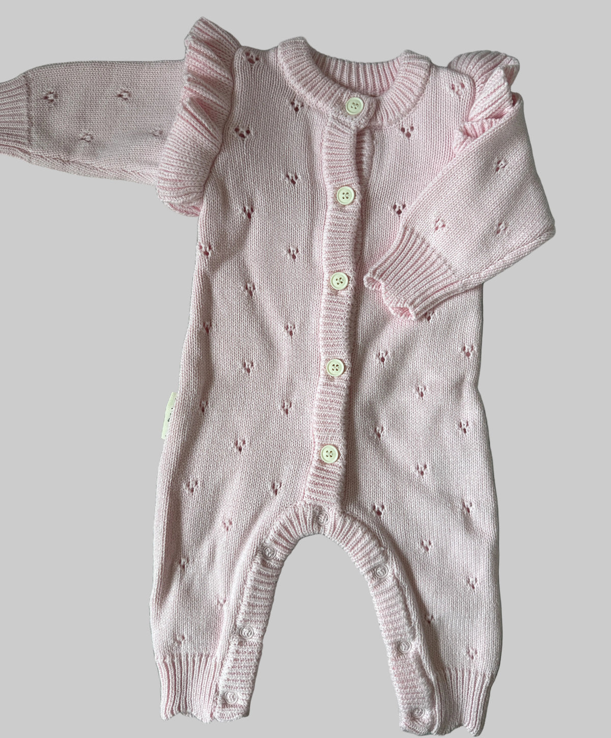Pink knitted baby romper with long sleeves 
