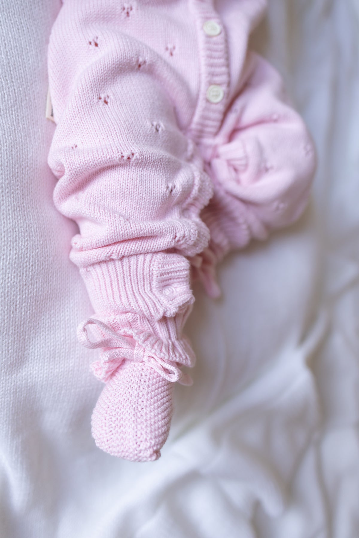 Pink baby outfit withromper and pants on a white background