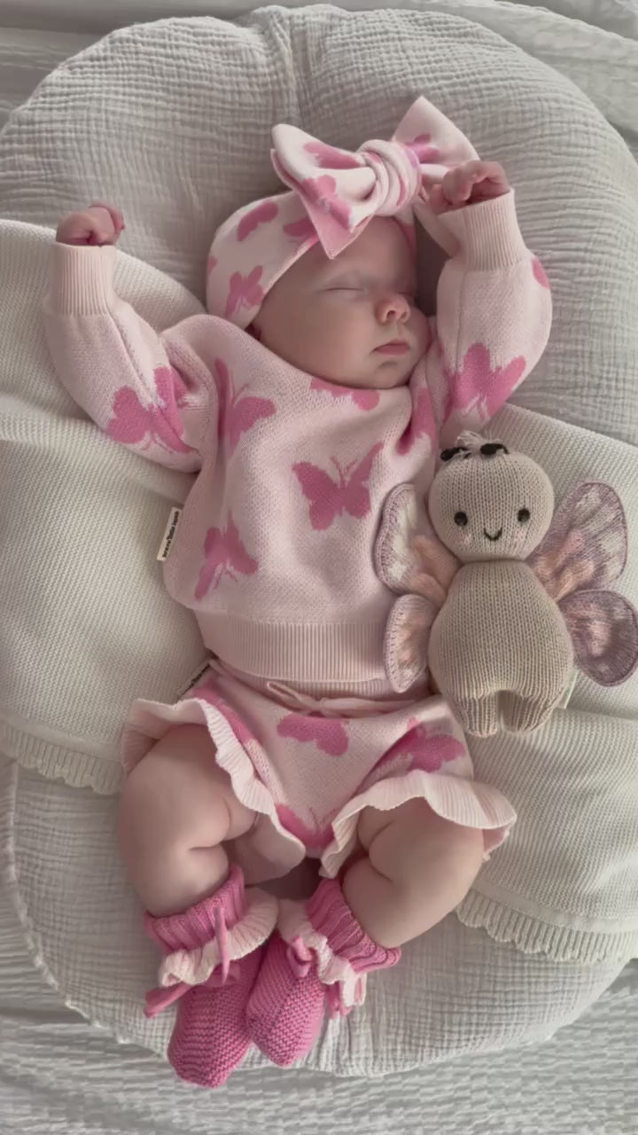 baby girl sleeping in knit butterfly pattern set with matching headband and booties