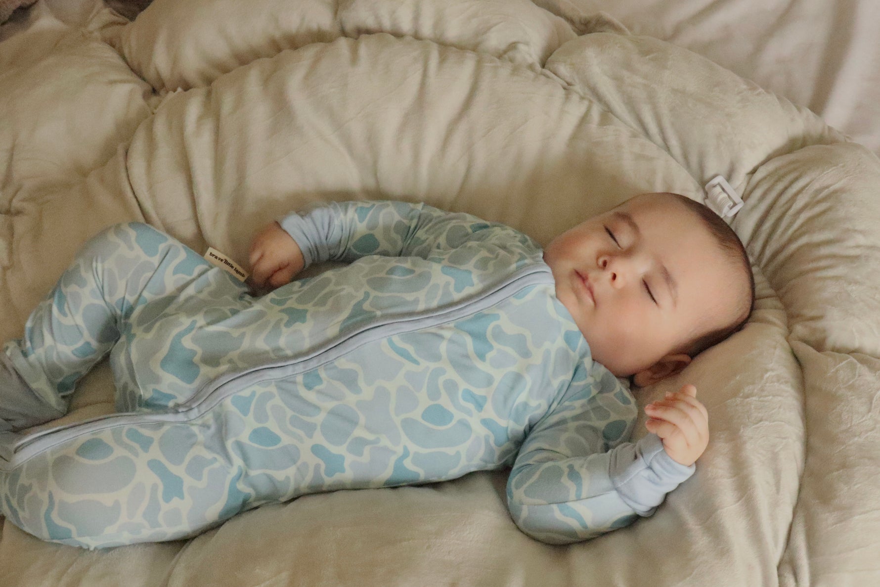 baby sleeping in pattern footie