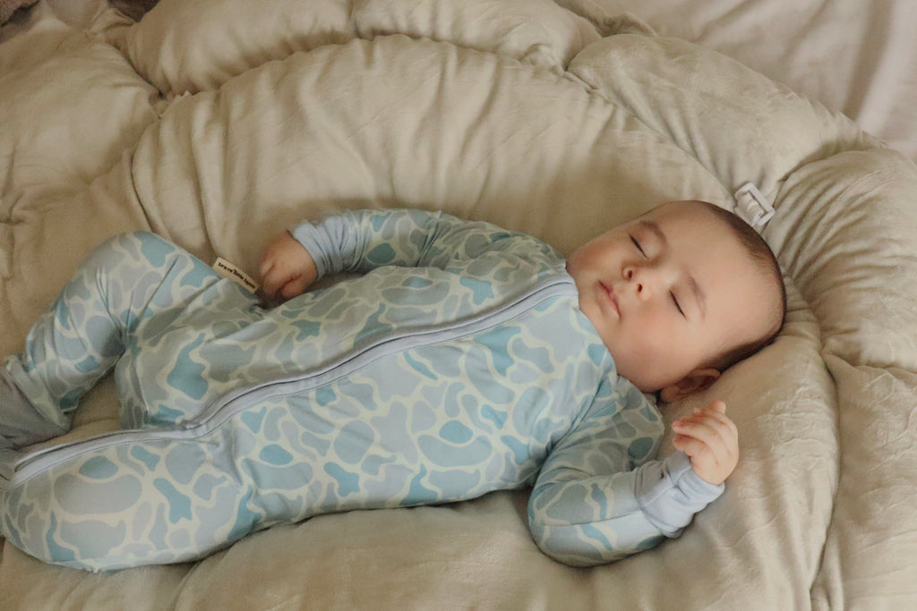 baby sleeping in pattern footie